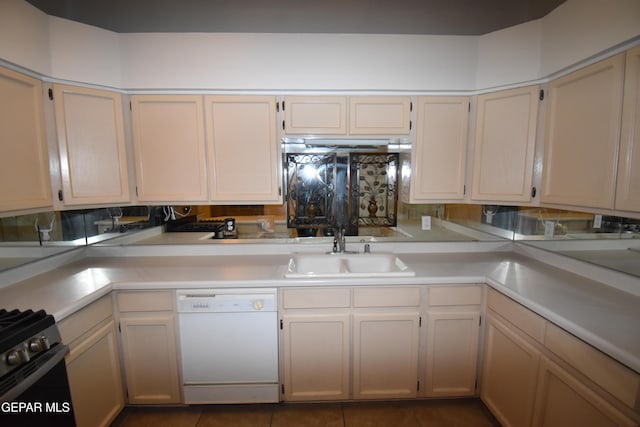 kitchen with black range with gas cooktop, light countertops, white dishwasher, and a sink