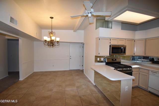 kitchen with stainless steel appliances, light countertops, visible vents, a peninsula, and ceiling fan with notable chandelier