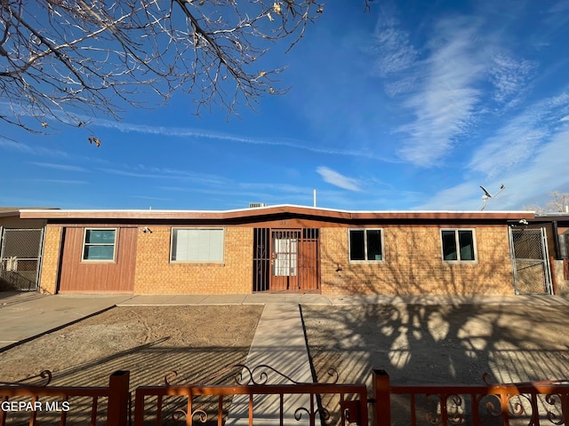 view of front of home featuring a fenced front yard and brick siding