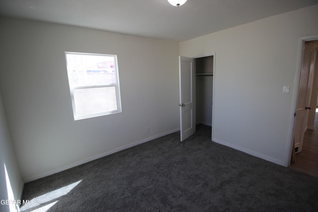 unfurnished bedroom with carpet floors, a closet, and baseboards