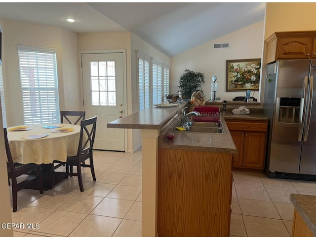 225 Peyton Rd, El Paso, TX 79928 - kitchen featuring stainless steel fridge with ice dispenser, a sink, a peninsula, dark countertops, and light tile patterned floors