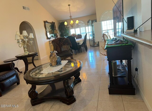 225 Peyton Rd, El Paso, TX 79928 - living area featuring light tile patterned floors, a chandelier, lofted ceiling, and baseboards
