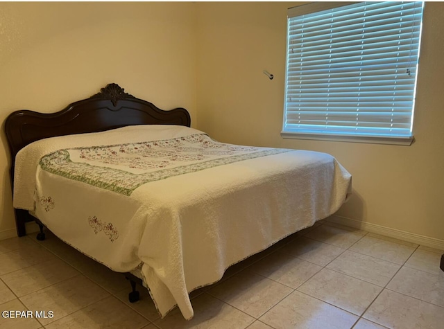225 Peyton Rd, El Paso, TX 79928 - bedroom with baseboards and light tile patterned floors