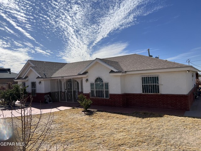 225 Peyton Rd, El Paso, TX 79928 - rear view of house with brick siding, stucco siding, and a patio area