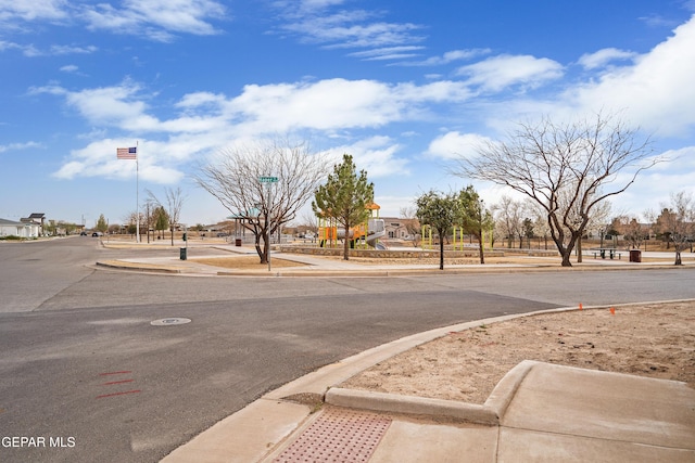 view of street featuring a residential view, curbs, and sidewalks