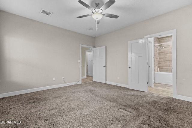 unfurnished bedroom featuring light carpet, ensuite bath, baseboards, and visible vents