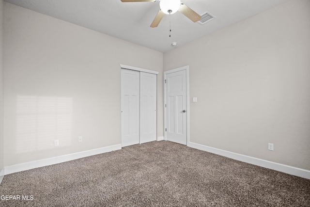 unfurnished bedroom with carpet floors, visible vents, and baseboards