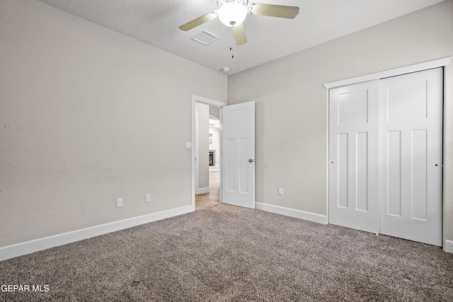 unfurnished bedroom featuring carpet floors, a closet, visible vents, and baseboards