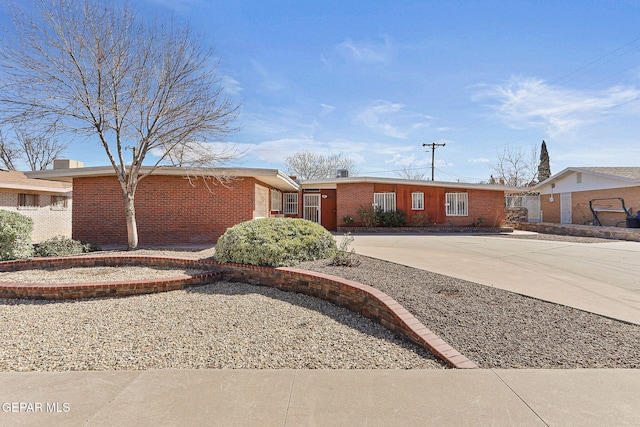 ranch-style house with brick siding and concrete driveway