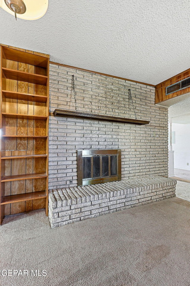 details with carpet flooring, a fireplace, visible vents, and a textured ceiling