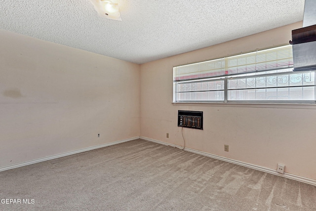 empty room with baseboards, carpet floors, and a textured ceiling