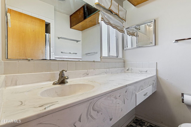 bathroom featuring backsplash and vanity