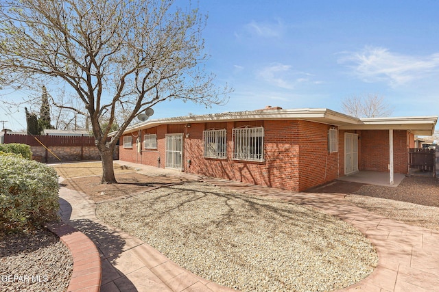 exterior space with fence and brick siding