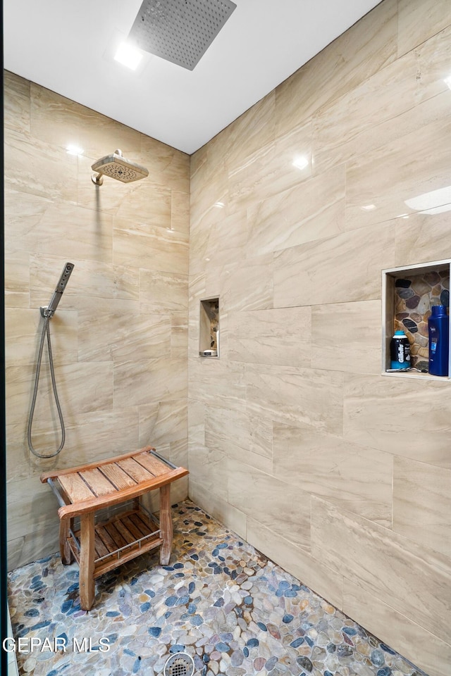 full bathroom with tiled shower