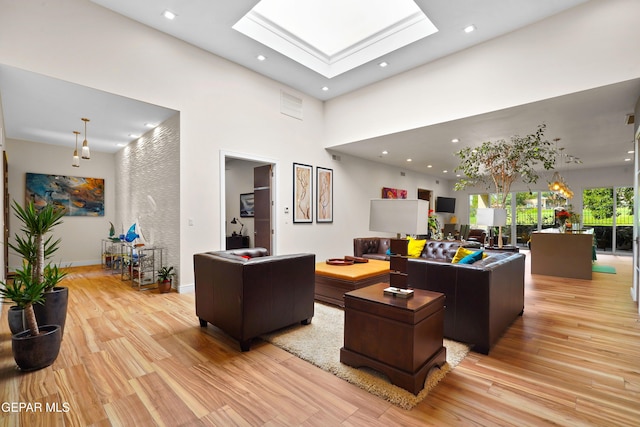 home office with a skylight, baseboards, wood finished floors, and recessed lighting