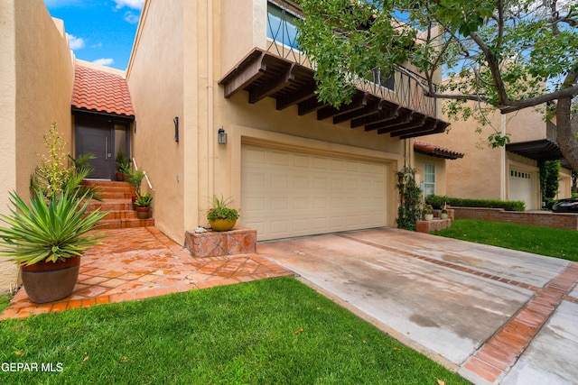 view of front facade with an attached garage, driveway, a tile roof, and stucco siding