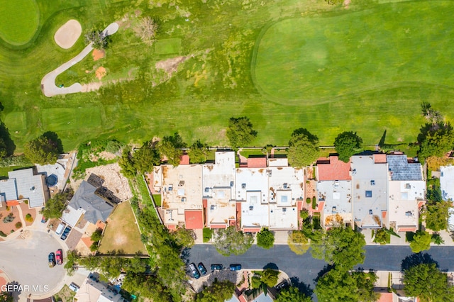 drone / aerial view with view of golf course and a residential view