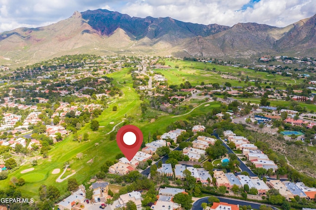 drone / aerial view featuring a residential view, view of golf course, and a mountain view