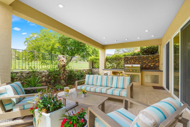 view of patio with an outdoor kitchen, fence, an outdoor living space, and area for grilling