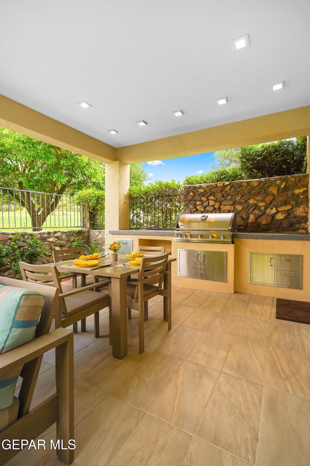 view of patio / terrace featuring outdoor dining space, fence, grilling area, and area for grilling