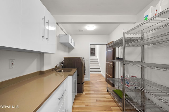 interior space featuring washer / dryer, visible vents, and a sink