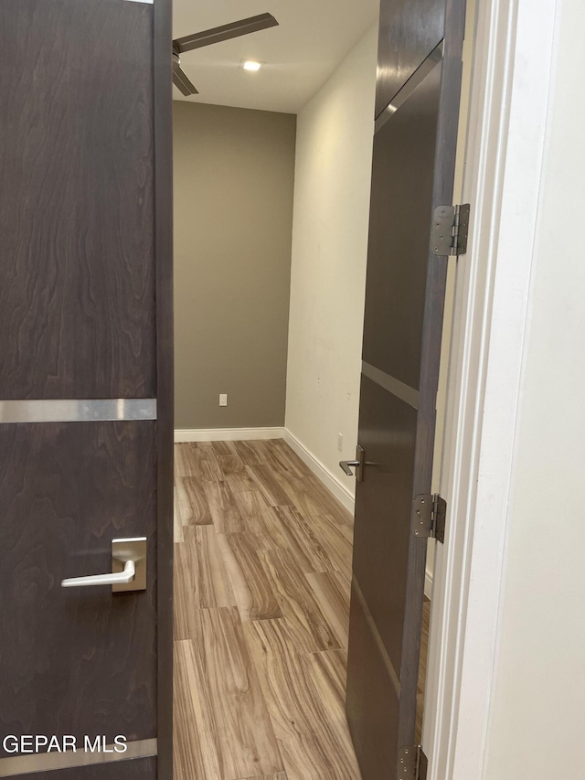 empty room with ceiling fan, recessed lighting, wood finished floors, and baseboards