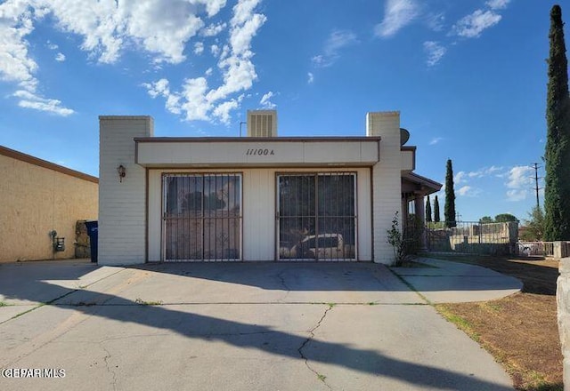 exterior space featuring a garage and fence