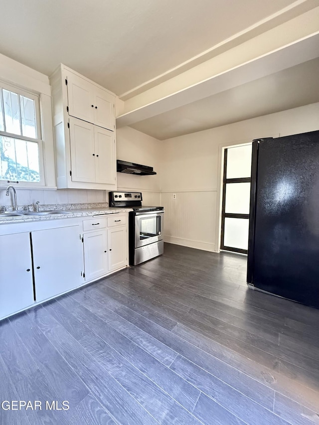 kitchen with under cabinet range hood, white cabinetry, stainless steel electric range, freestanding refrigerator, and dark wood finished floors