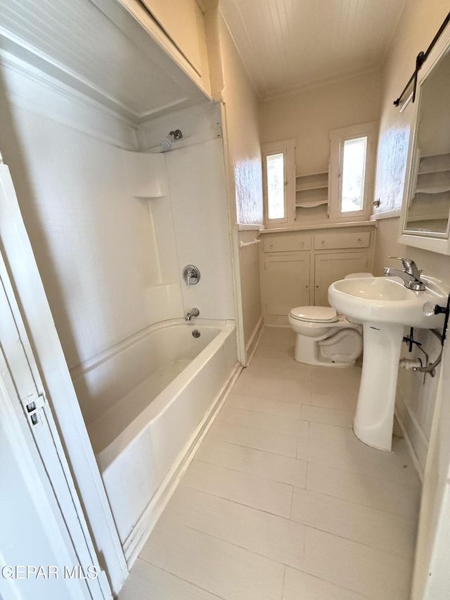 bathroom featuring shower / bathing tub combination and toilet