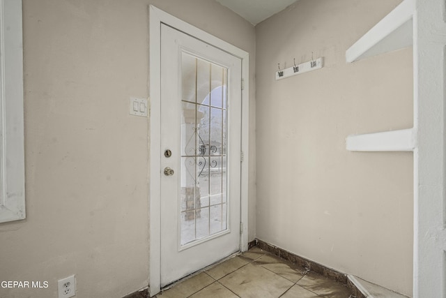 doorway with light tile patterned floors