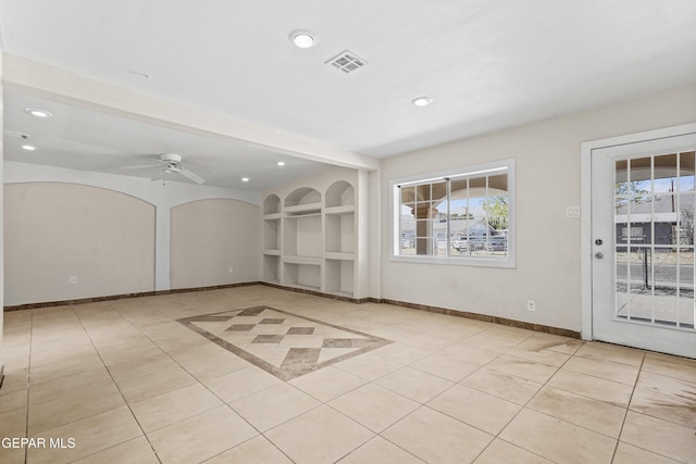 unfurnished room with visible vents, baseboards, built in features, recessed lighting, and a ceiling fan