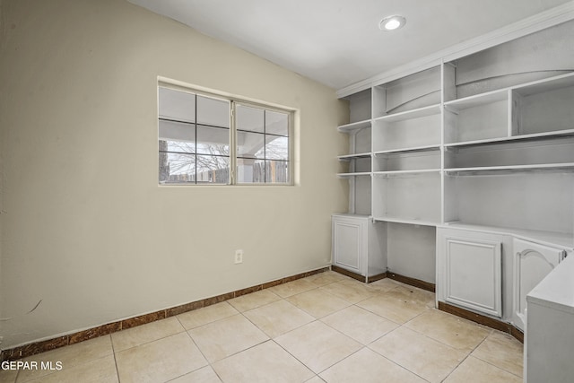 unfurnished office featuring light tile patterned floors and baseboards