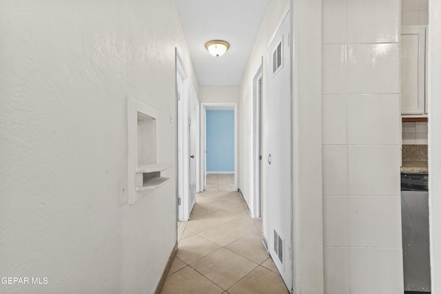 hallway with light tile patterned floors and visible vents