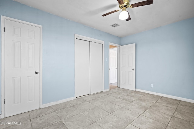 unfurnished bedroom featuring a closet, visible vents, a ceiling fan, and baseboards