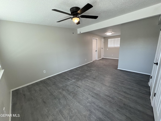 unfurnished room featuring dark wood-style floors, a ceiling fan, baseboards, and a textured ceiling