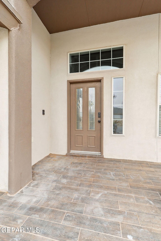 entrance to property with stucco siding