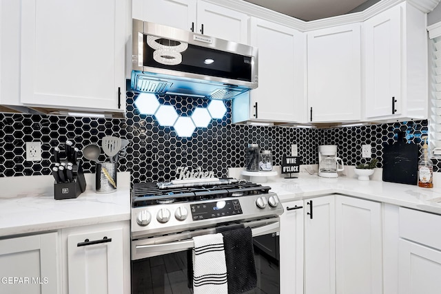 kitchen with white cabinetry, appliances with stainless steel finishes, and backsplash