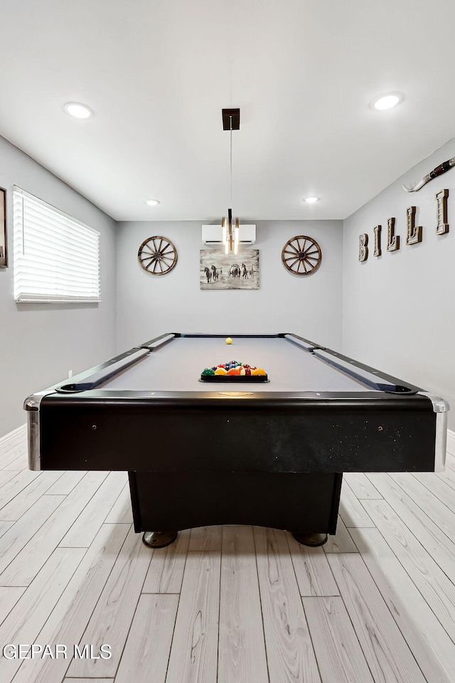 playroom with light wood-type flooring, a wall unit AC, and recessed lighting