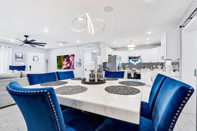 dining space featuring a ceiling fan, recessed lighting, visible vents, and light wood finished floors