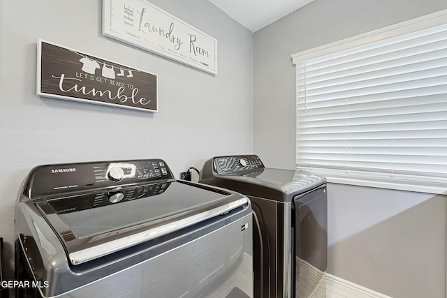 washroom featuring laundry area and separate washer and dryer