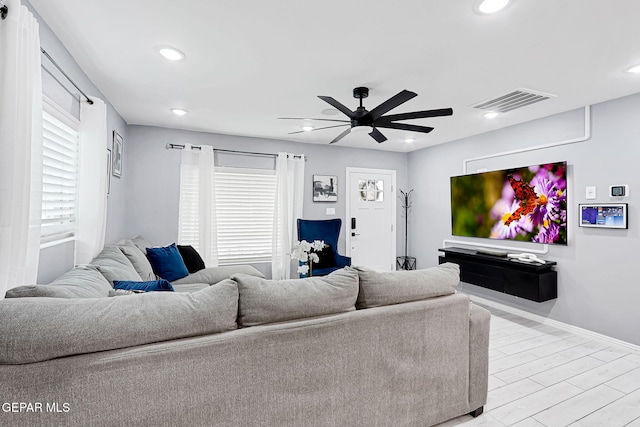 living area featuring recessed lighting, visible vents, a ceiling fan, wood finished floors, and baseboards