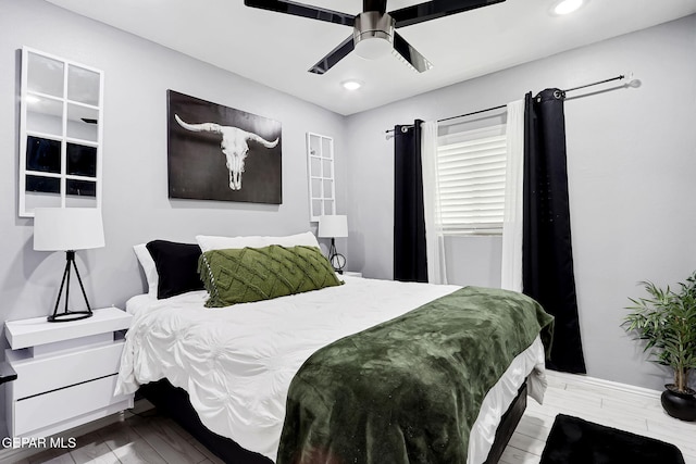 bedroom with a ceiling fan, wood finished floors, and recessed lighting