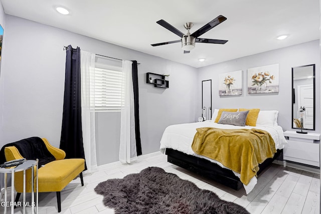 bedroom featuring a ceiling fan, recessed lighting, light wood-style floors, and baseboards