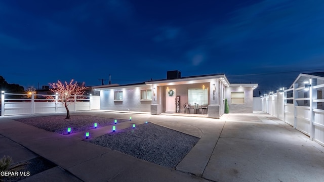 view of front of home with fence and stucco siding