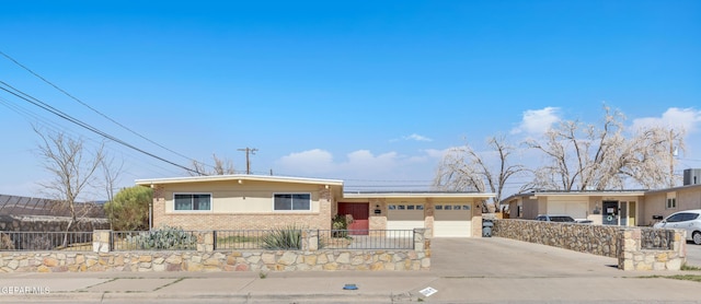 ranch-style house featuring a garage, a fenced front yard, concrete driveway, and brick siding