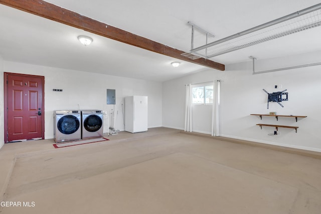 garage with washer and clothes dryer, electric panel, and baseboards