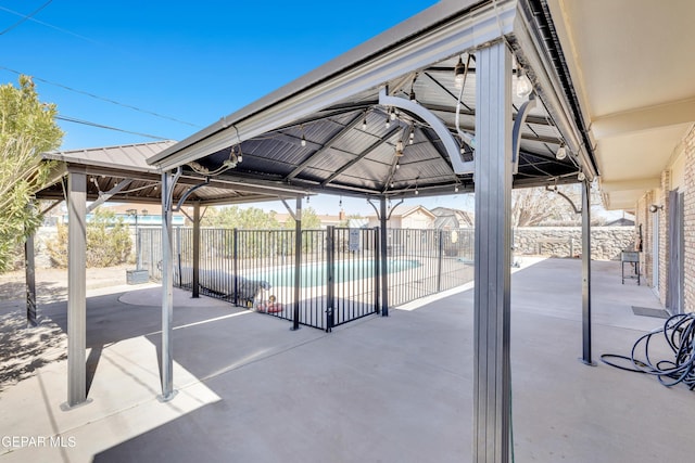 view of patio with a fenced in pool, fence, and a gazebo