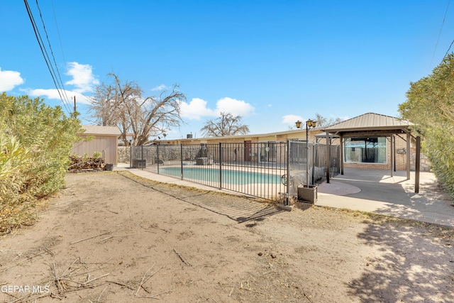 view of pool with a fenced in pool, an outbuilding, a gazebo, a patio area, and fence