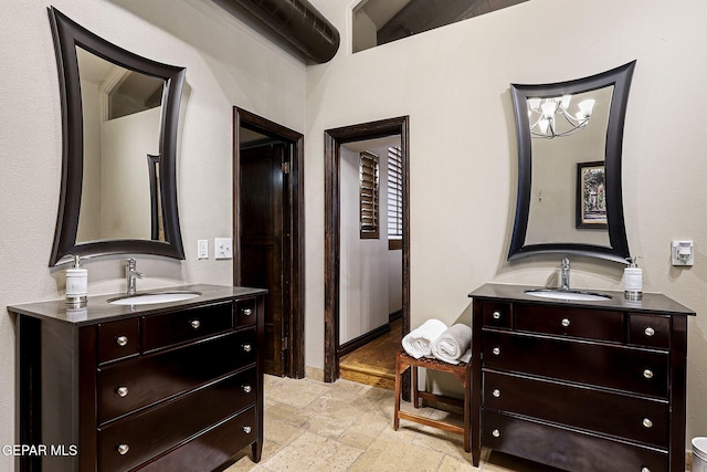 bedroom with a sink and stone tile floors