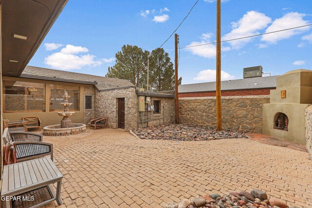 view of patio featuring a fireplace